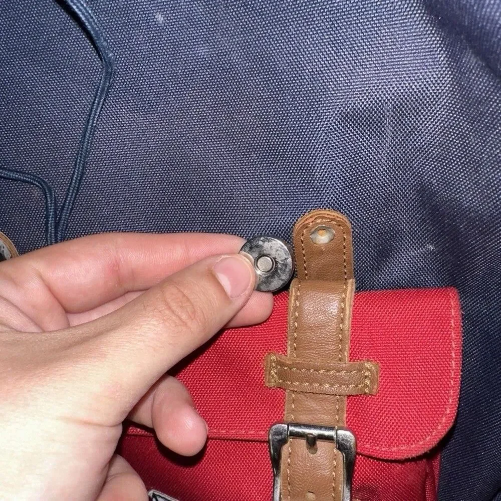 Herschel backpack with pocket. One button is missing, kept it in the front zip.